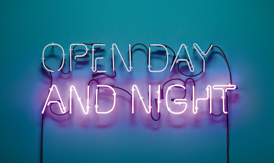 Image of a neon sign that says "open day and night"