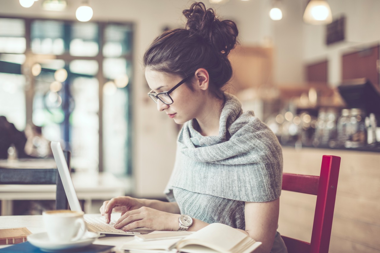 Girl on laptop in shop