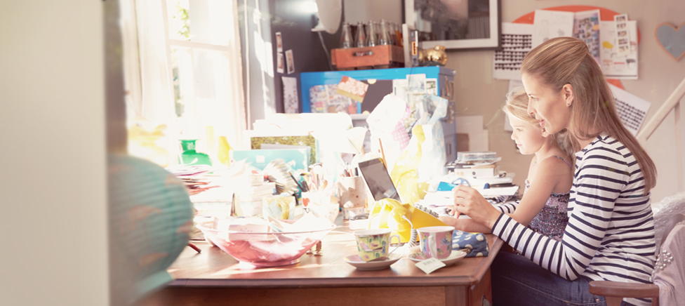 Mother & daughter working at desk