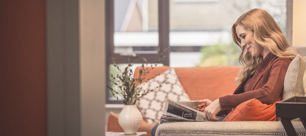 Woman sitting on sofa reading