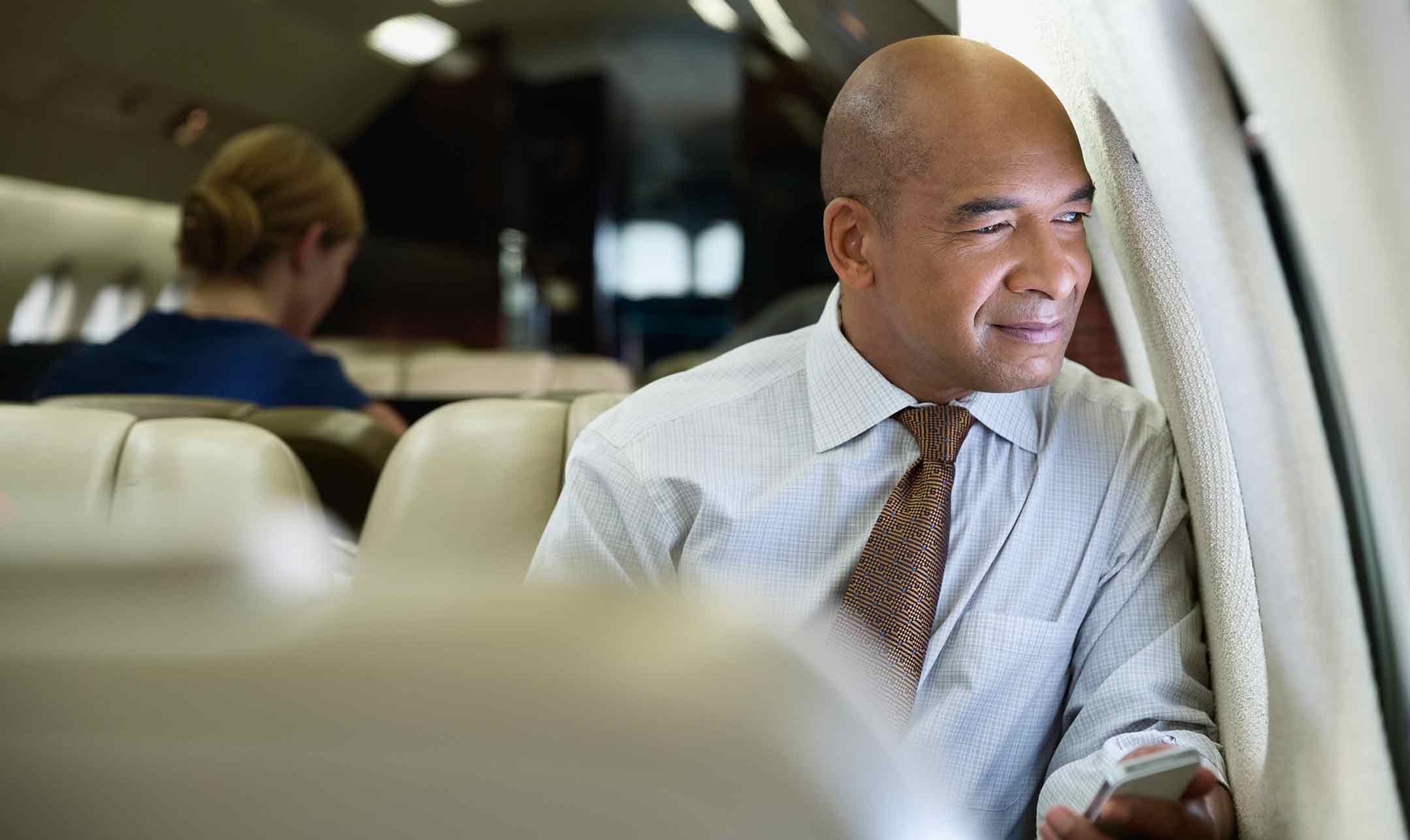 Man loooking out plane window
